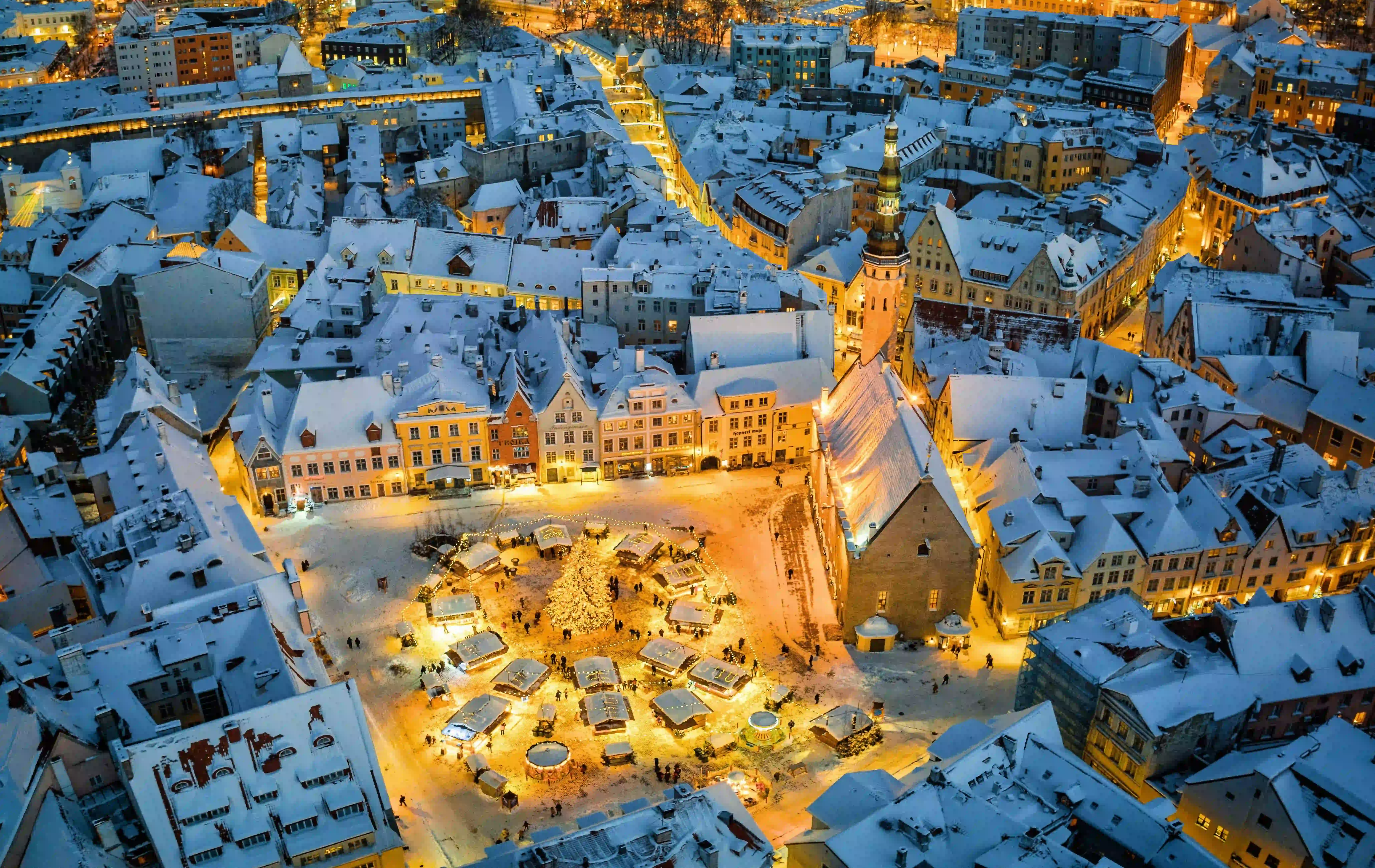 European Christmas Market Holiday Market covered in Snow in Evening Aerial Drone Shot