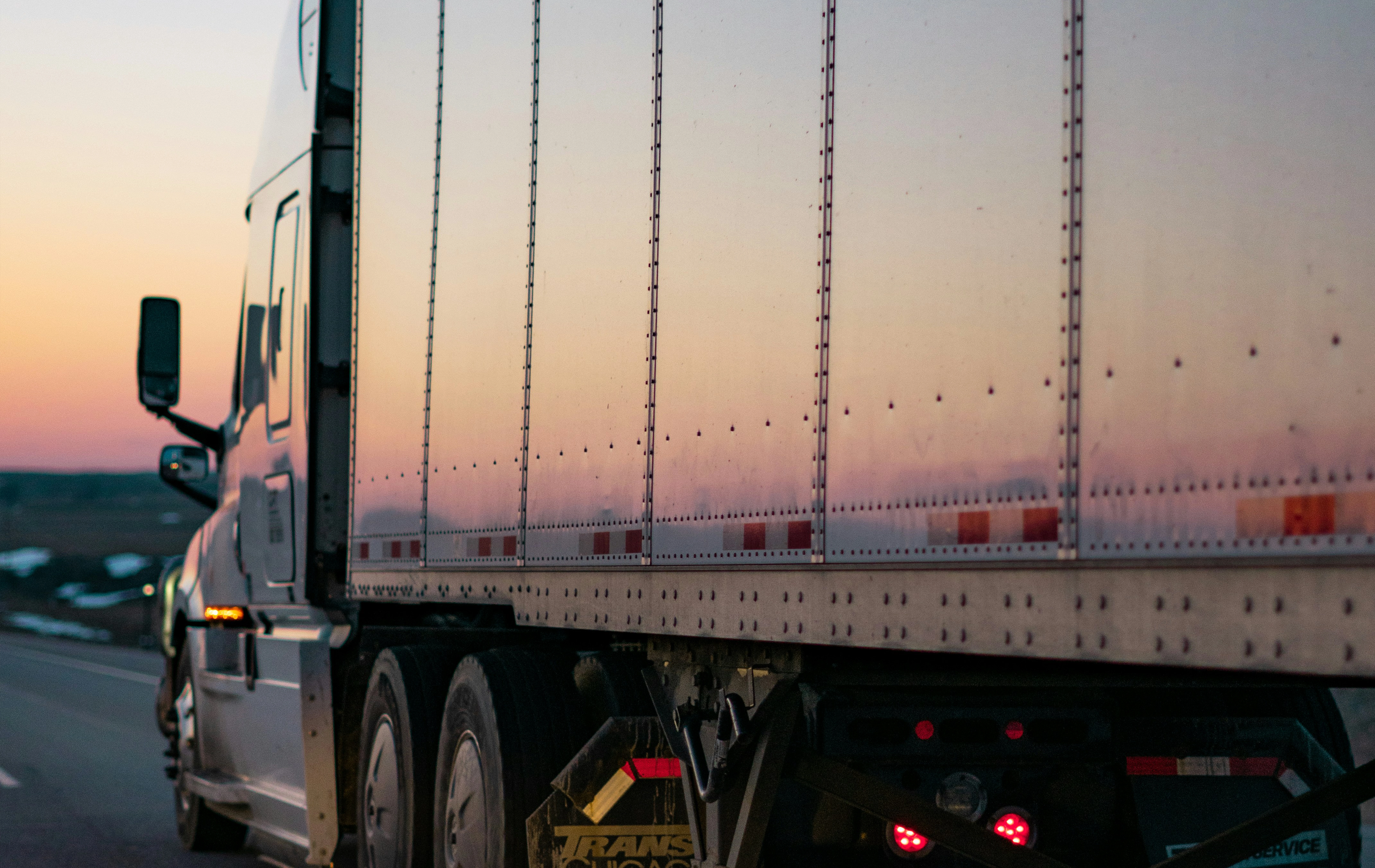 Semi-Truck on Road at Sunset