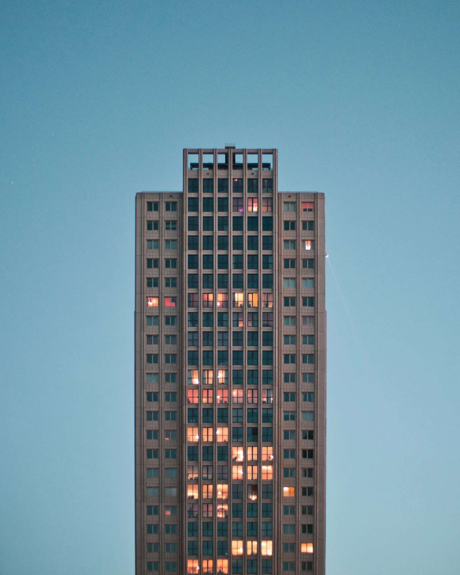 Existing high-rise facade with occupied upper floors, viewed from a drone-threat perspective to illustrate exposure beyond the ground plane.