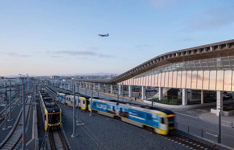 protective design for LAX/Metro Transit Center completed exterior at dusk with airplane